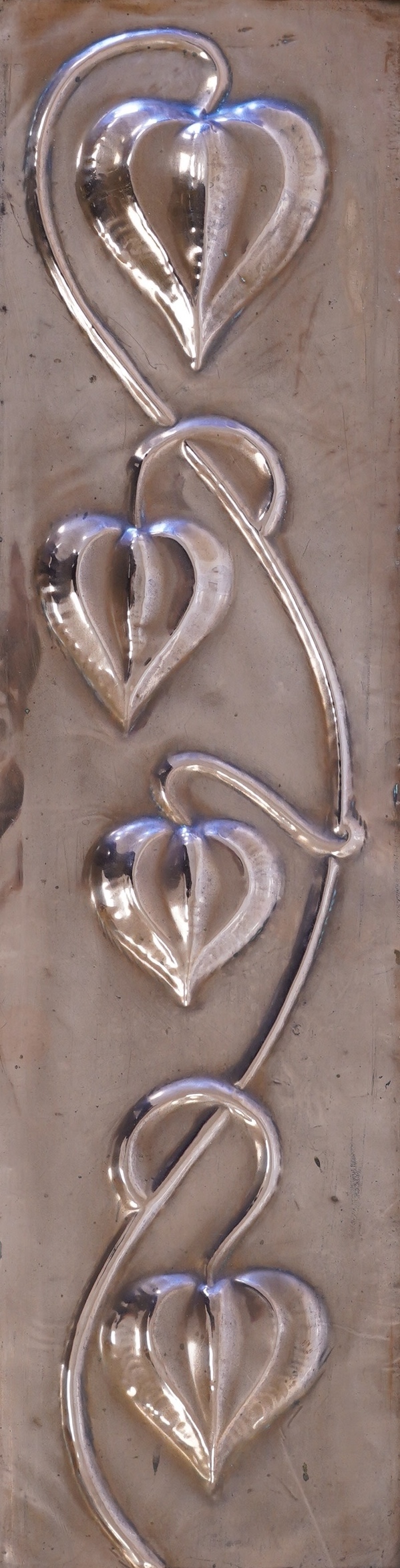 In the manner of Pearson, an Arts & Crafts embossed copper panel, oak framed, 59 x 24cm including frame. Condition - fair to good